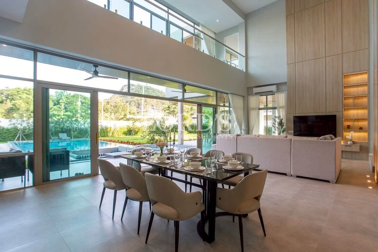 Dining area with double-height windows
