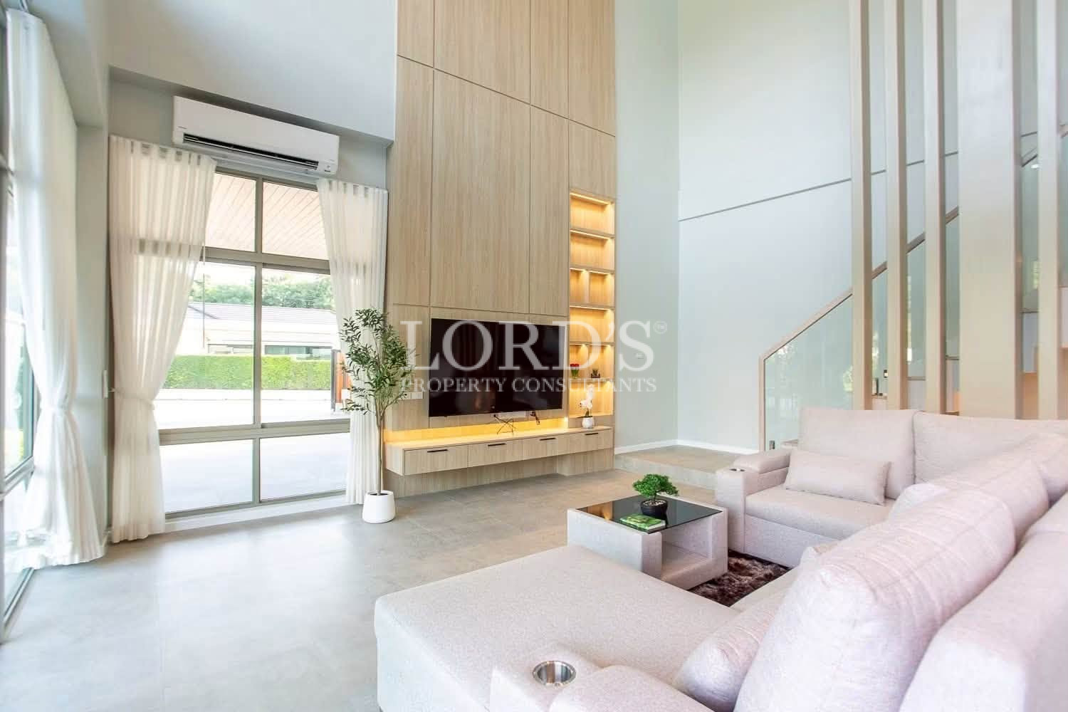 Open-plan living room with soaring ceilings