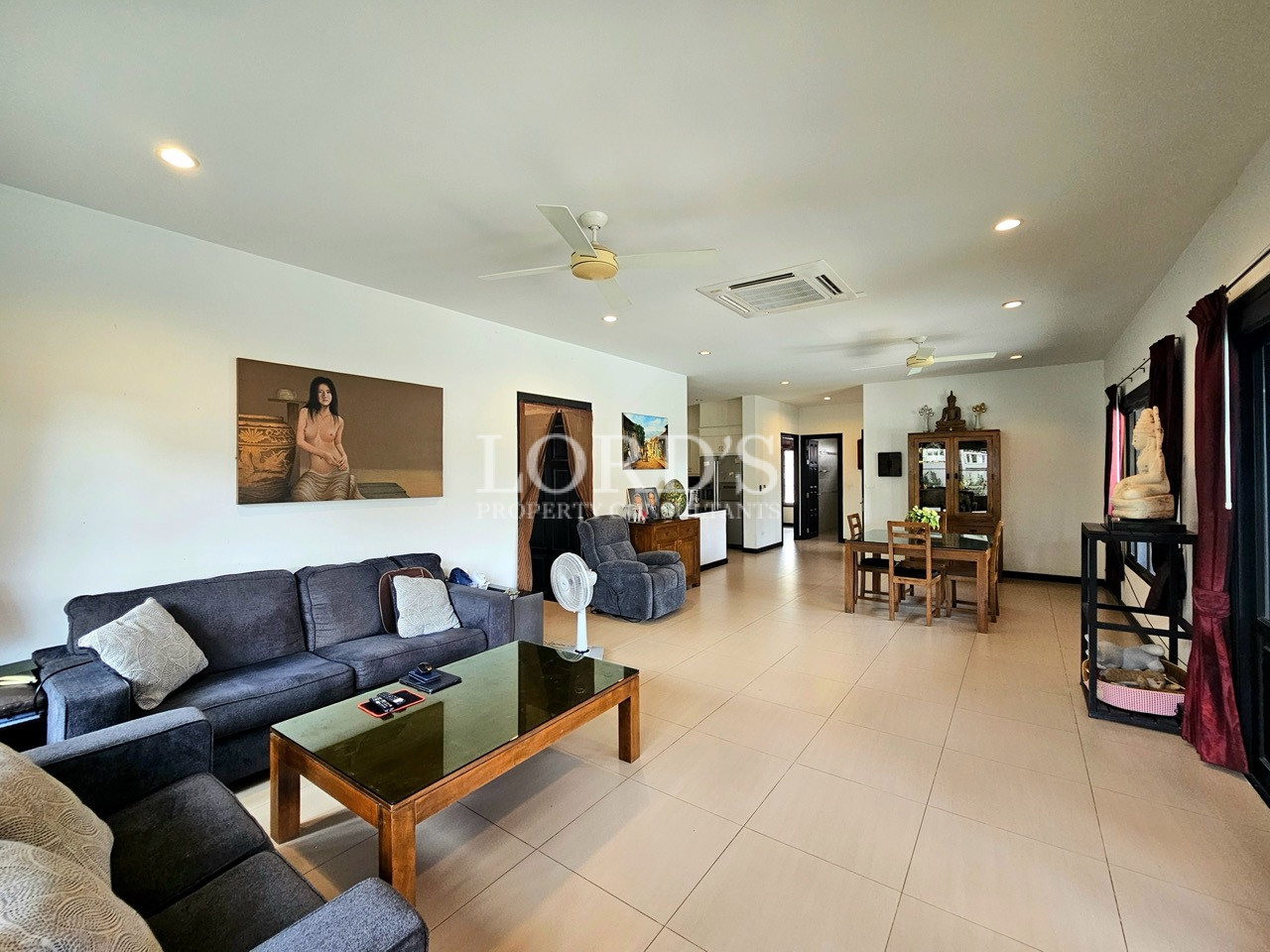 Spacious open-plan living and dining area with comfortable seating and modern finishes