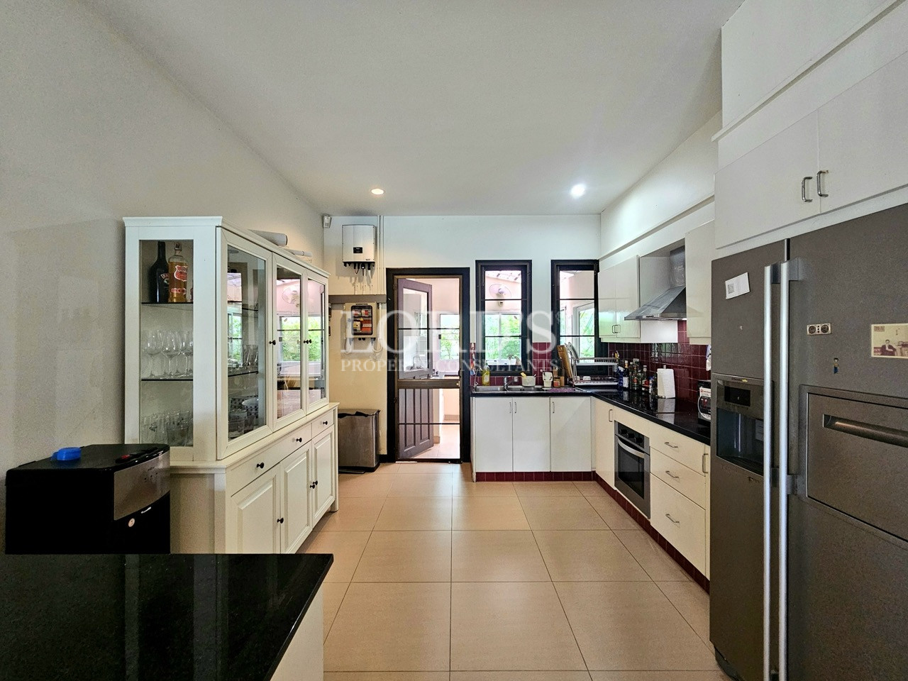 Spacious modern kitchen with premium appliances, custom cabinetry, and open layout