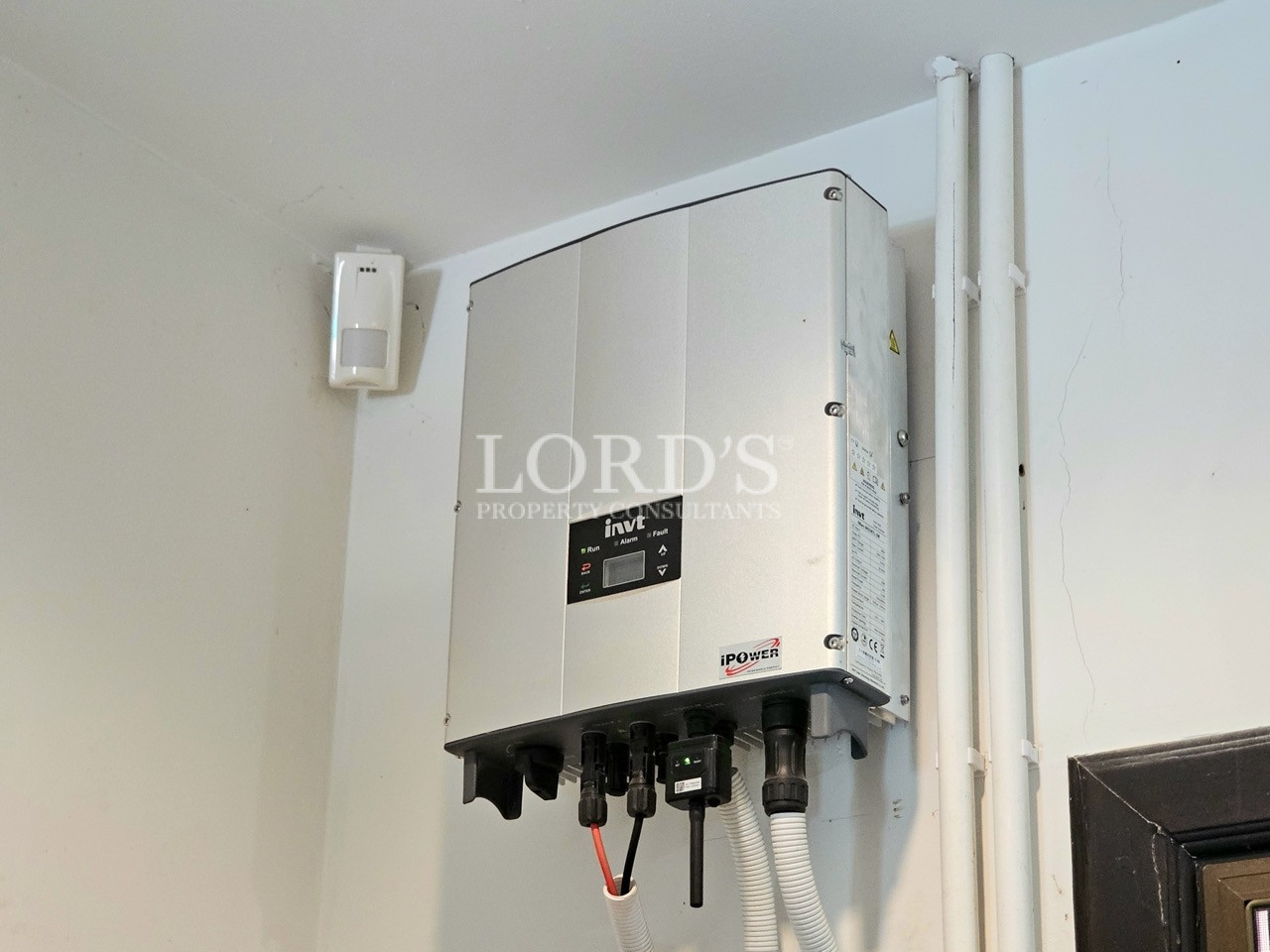Wall-mounted solar power inverter installed in a dedicated utility room