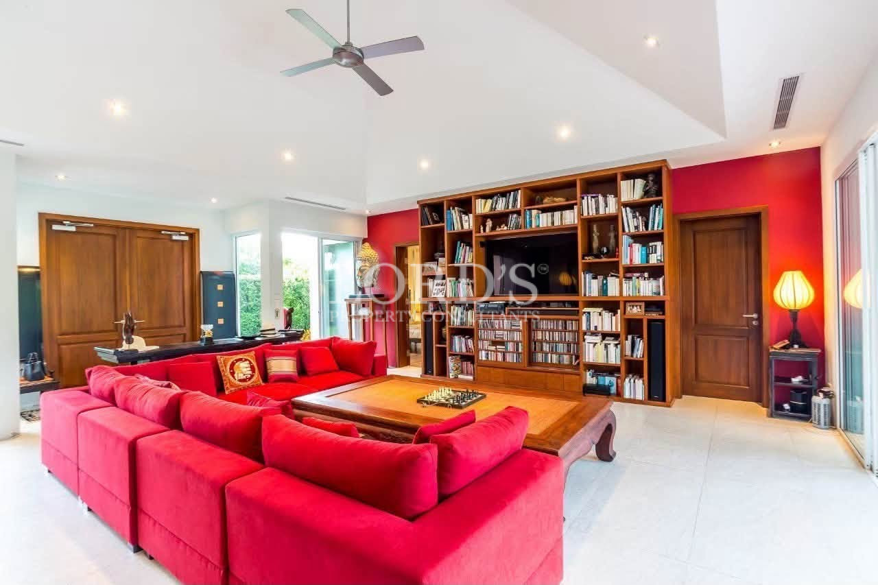 Bright living room with library wall
