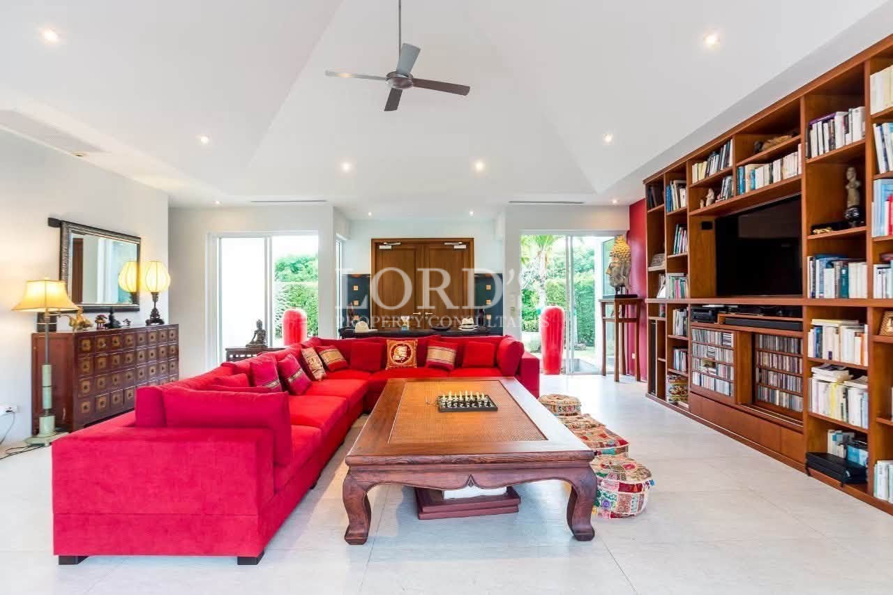 Open-plan living room with red sectional sofa