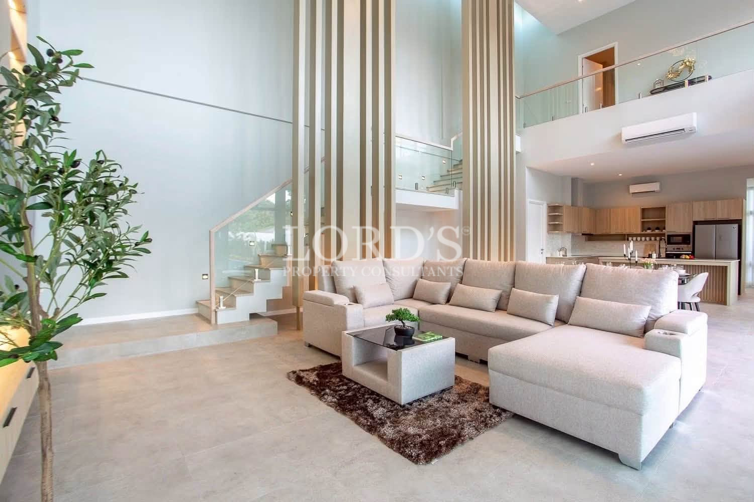 Double-height living room with floor-to-ceiling windows