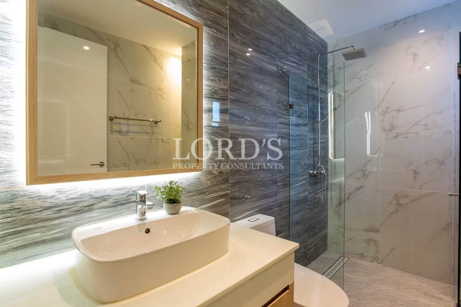 Modern bathroom with dark stone accent wall