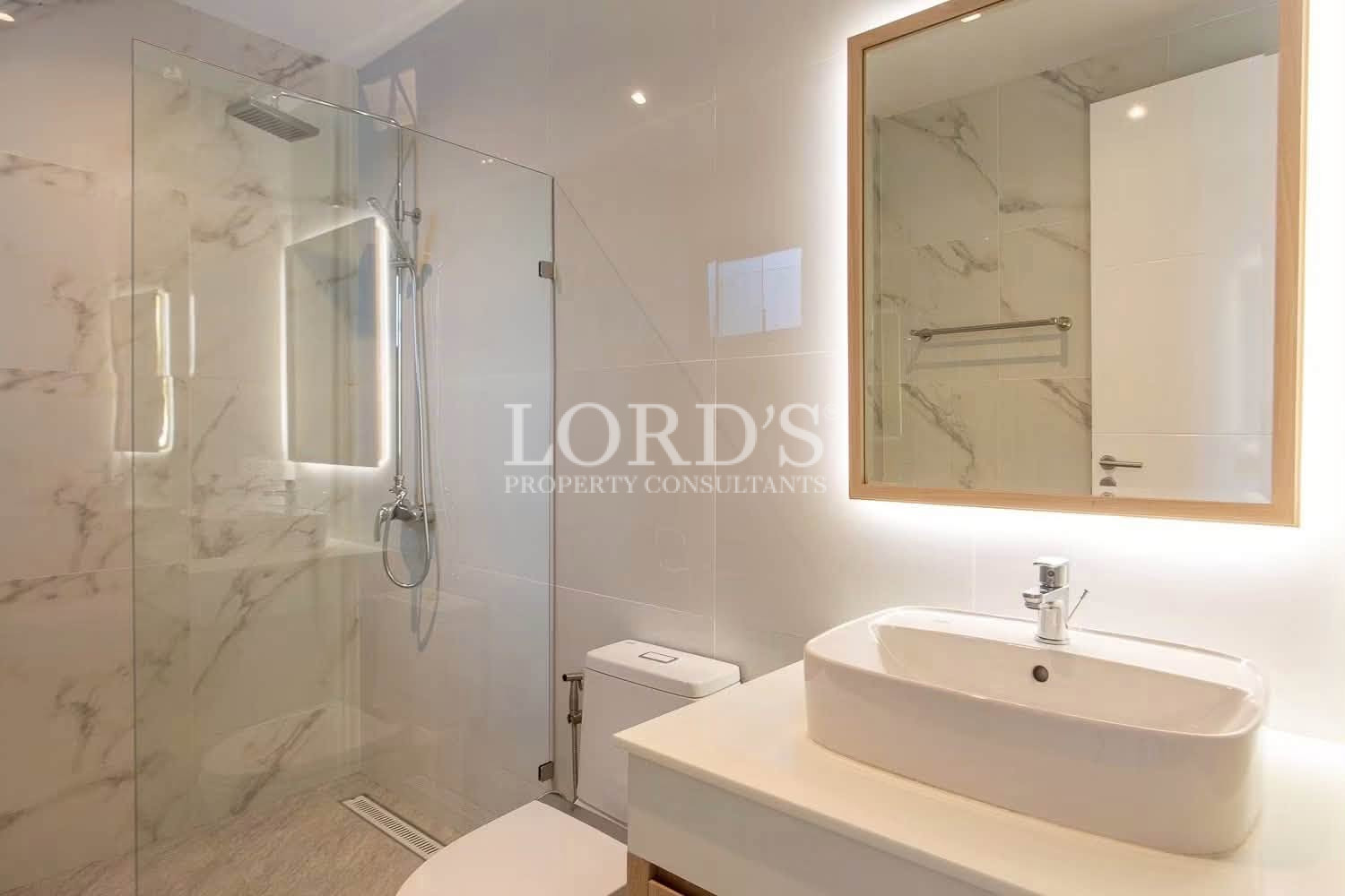 Modern bathroom with illuminated vanity mirror