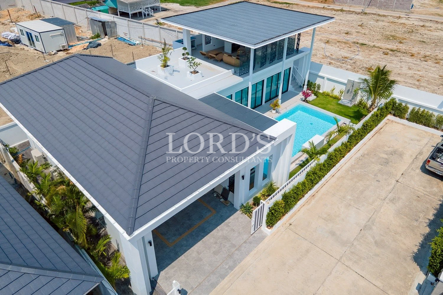 Top-down aerial view of villa with swimming pool