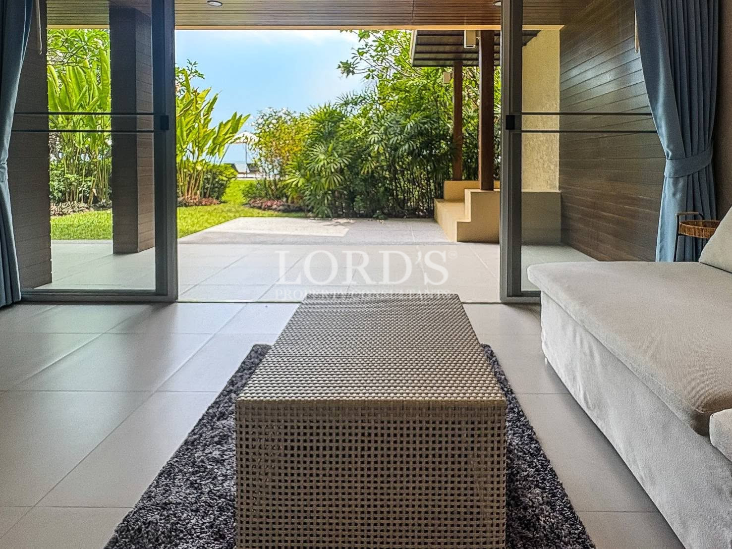 Covered villa entrance with tropical landscaping