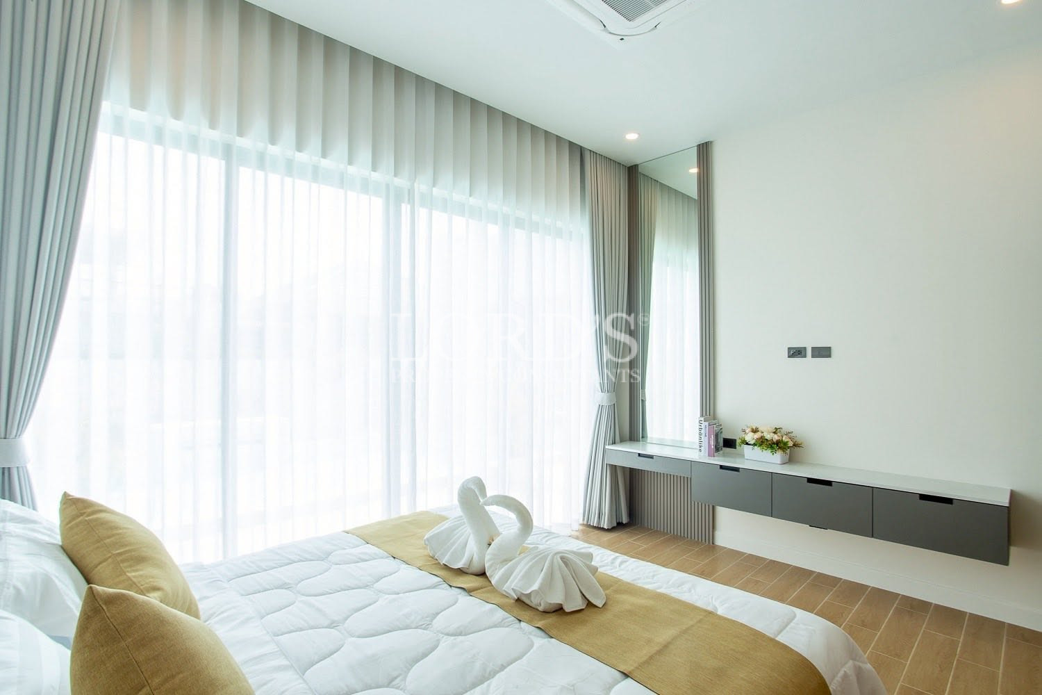 Bright bedroom with floor-to-ceiling curtains