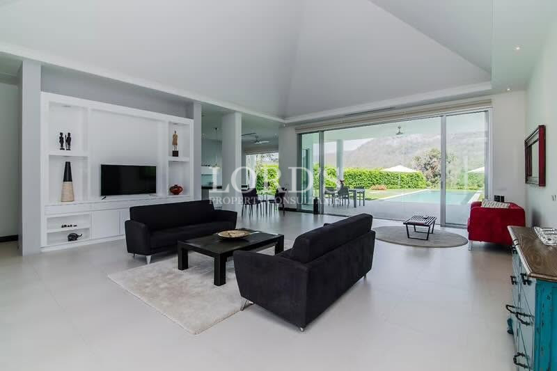 Open-concept living room with large windows overlooking the garden
