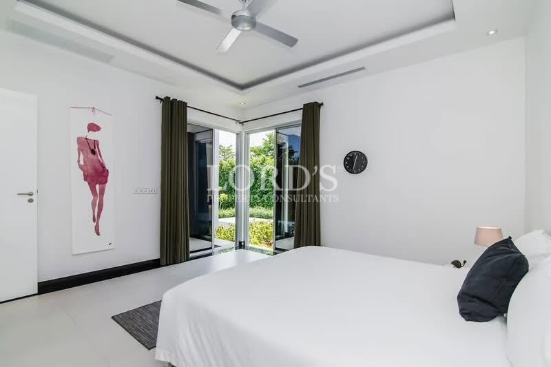 Minimalist bedroom with ceiling fan and built-in storage