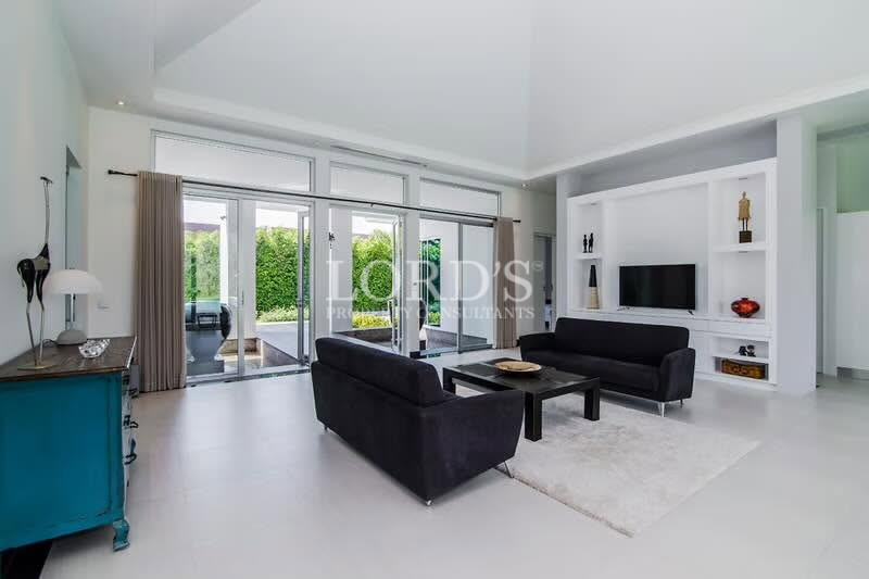 Bright modern living room with large windows and garden views