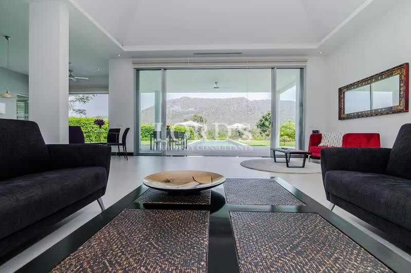 Modern bedroom with floor-to-ceiling windows and mountain views