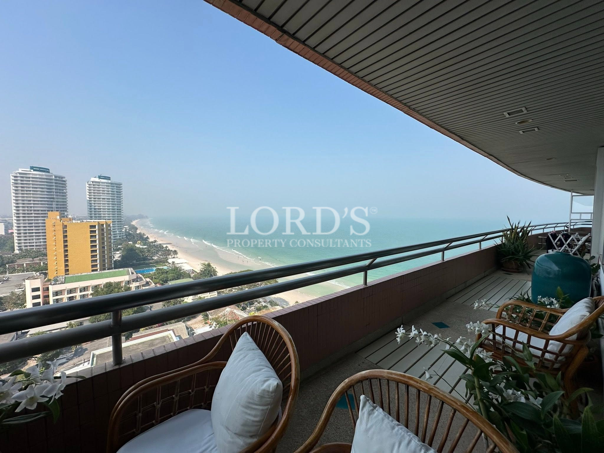 Modern balcony overlooking the ocean and city skyline