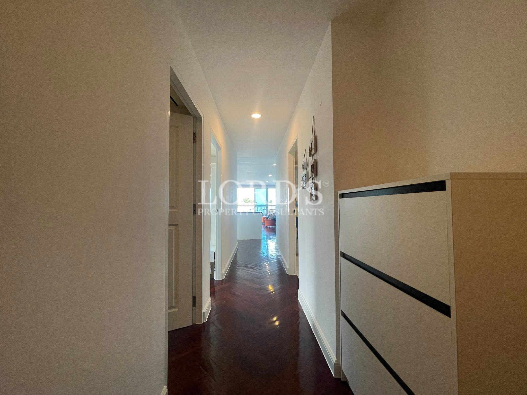 Modern hallway with dark wood herringbone flooring