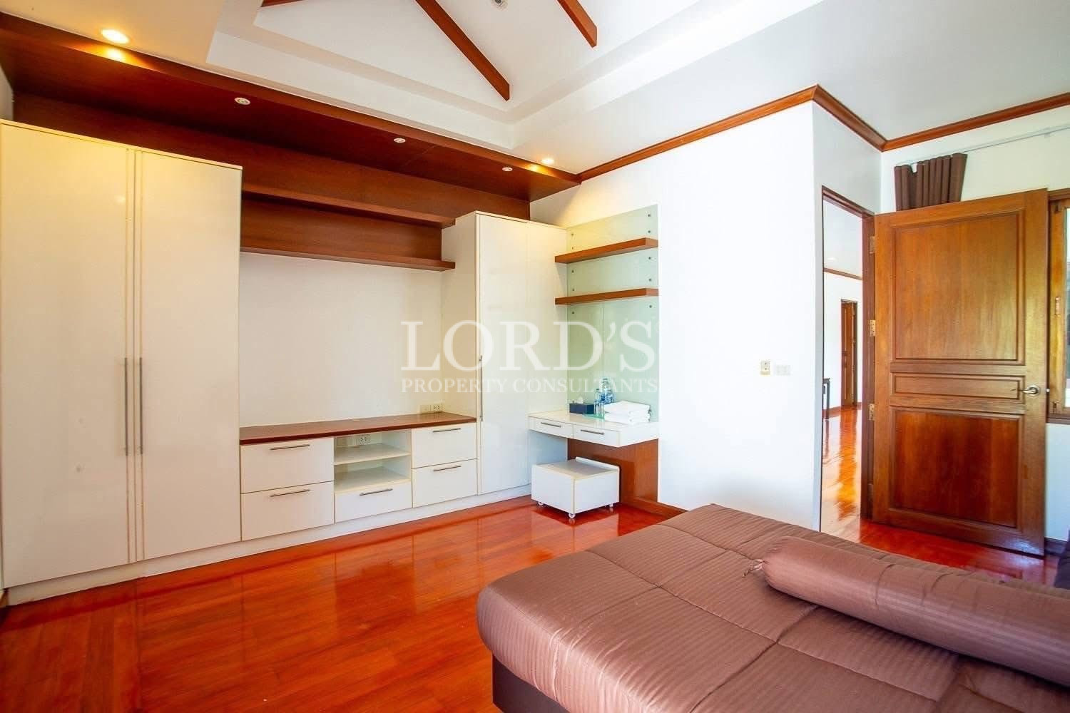 Spacious bedroom with timber ceiling details