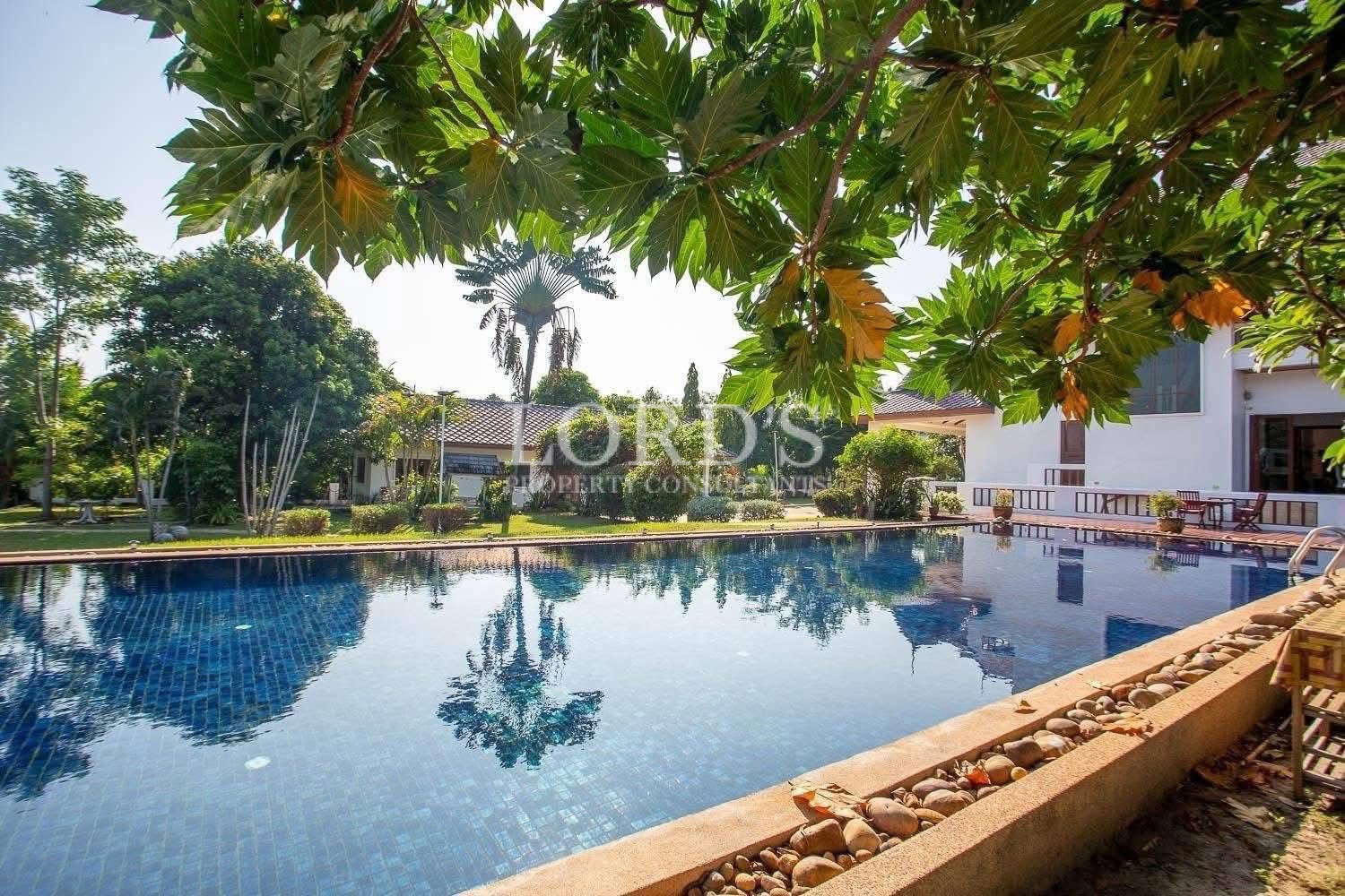 Beautiful tropical garden with mature trees surrounding a residential property