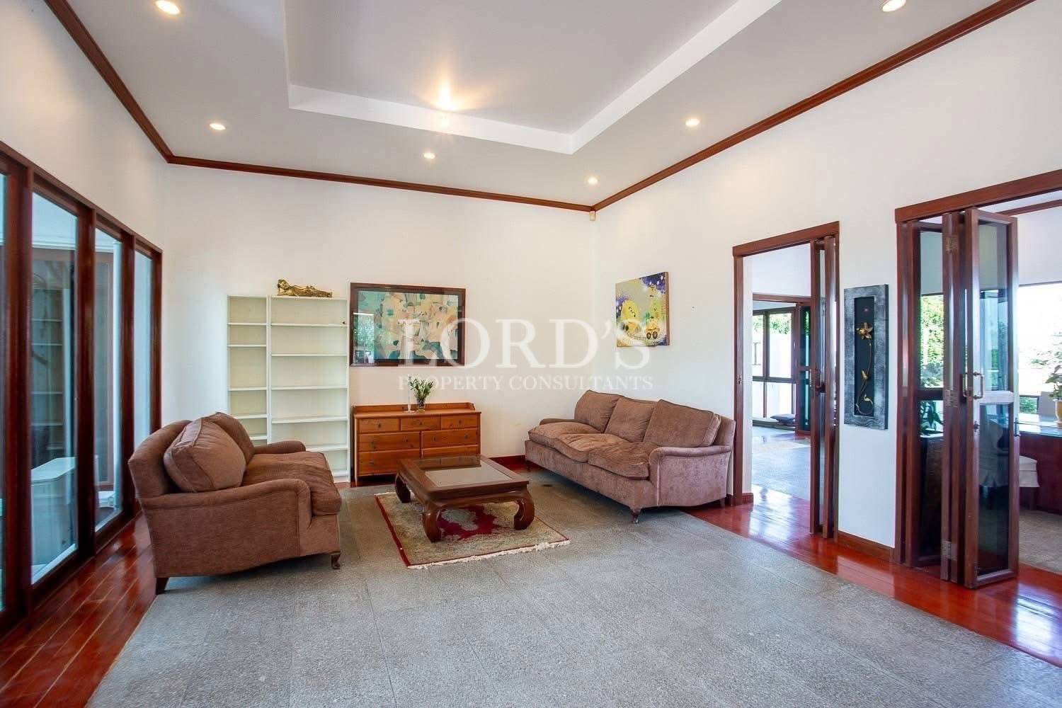 Modern open living area with ceiling lighting and natural daylight
