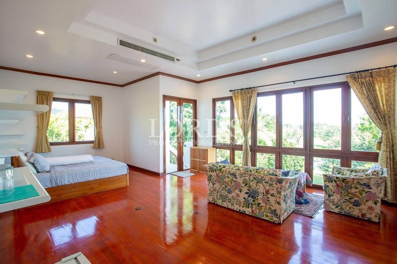 Spacious home interior with large windows and wooden ceiling accents