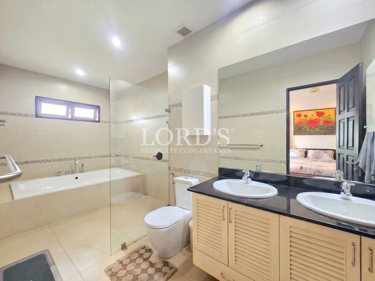 Modern bathroom with double vanity, glass-enclosed shower, built-in bathtub, and contemporary finishes