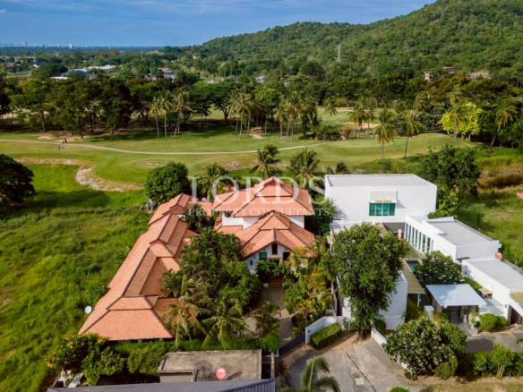 Tropical villa surrounded by lush palm trees and landscaped garden
