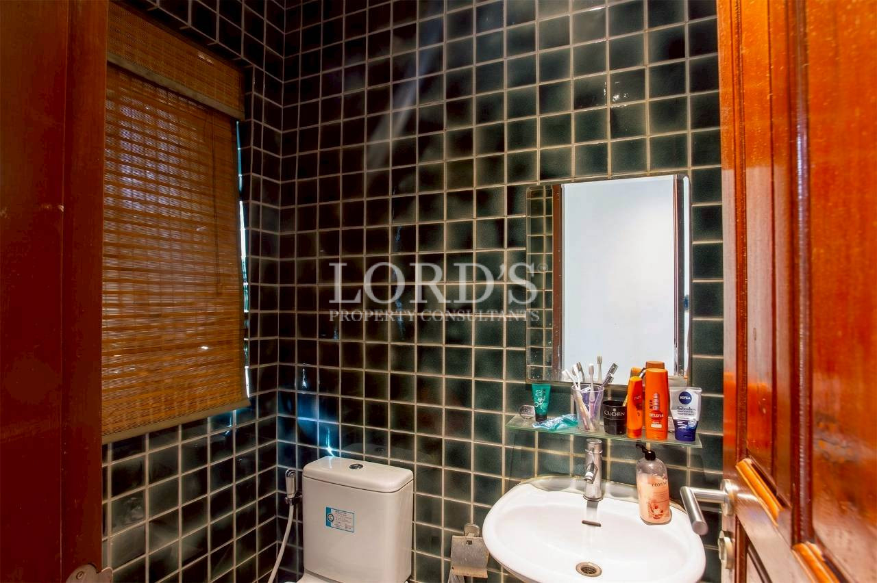 Contemporary bathroom with mosaic tile walls and modern fixtures