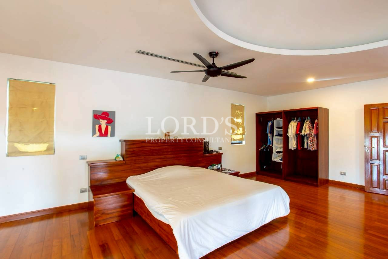 Spacious bedroom with ceiling fan and contemporary ceiling details