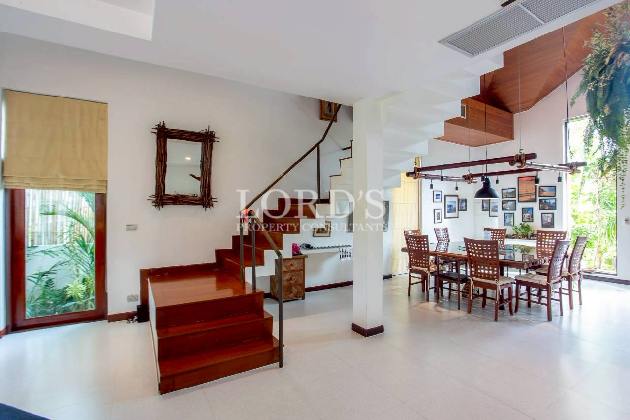 Bright open-plan living room with staircase and modern interior