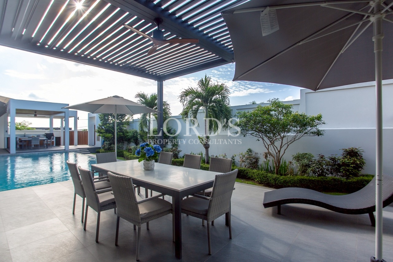 Modern poolside terrace with pergola