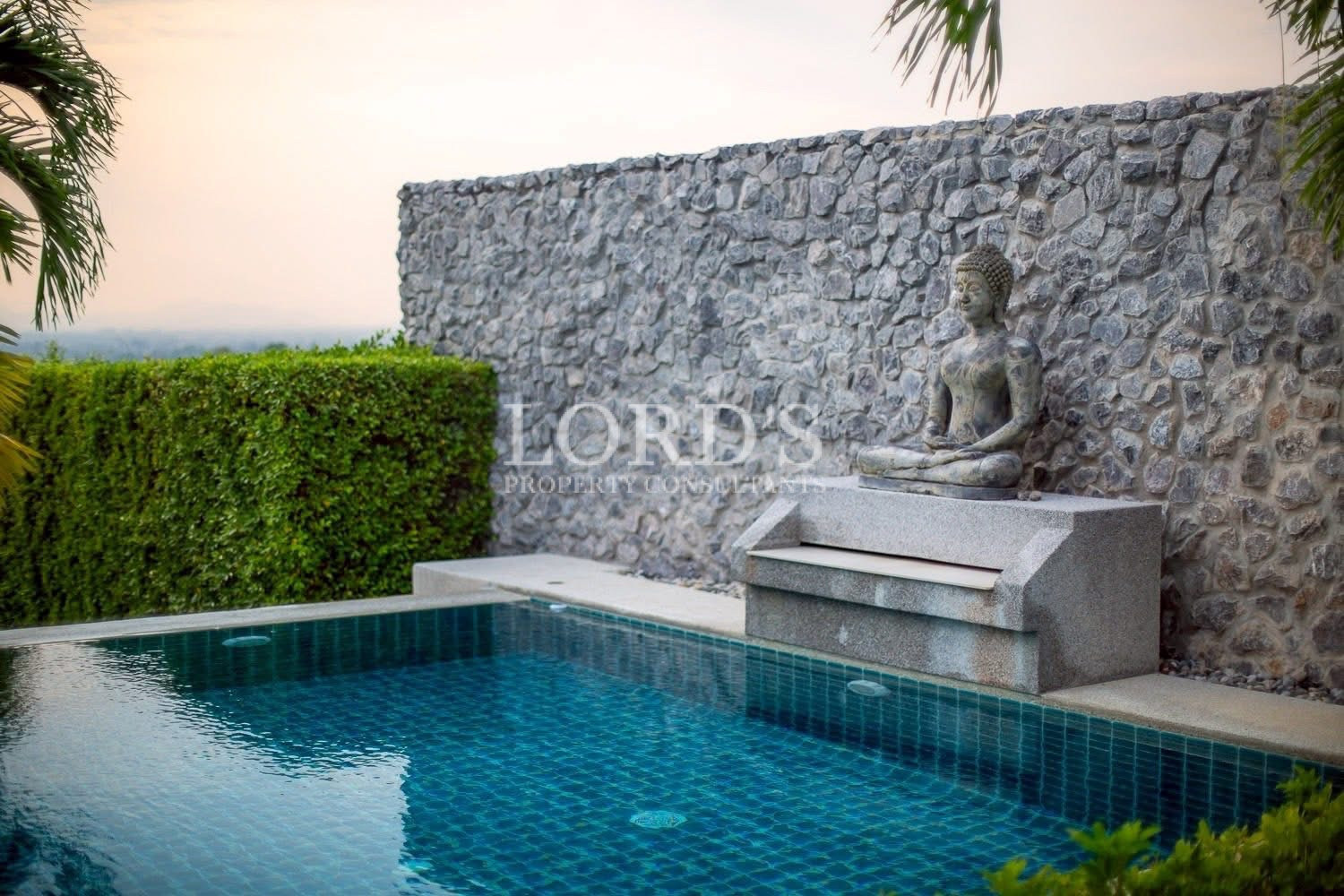 Swimming pool with stone waterfall feature