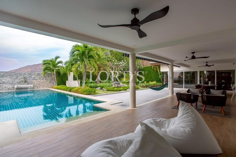 Covered poolside terrace with lounge seating
