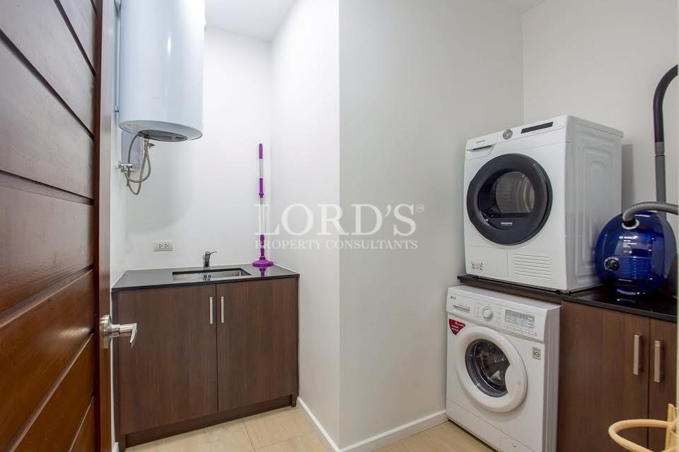 Laundry room with stacked washer and dryer