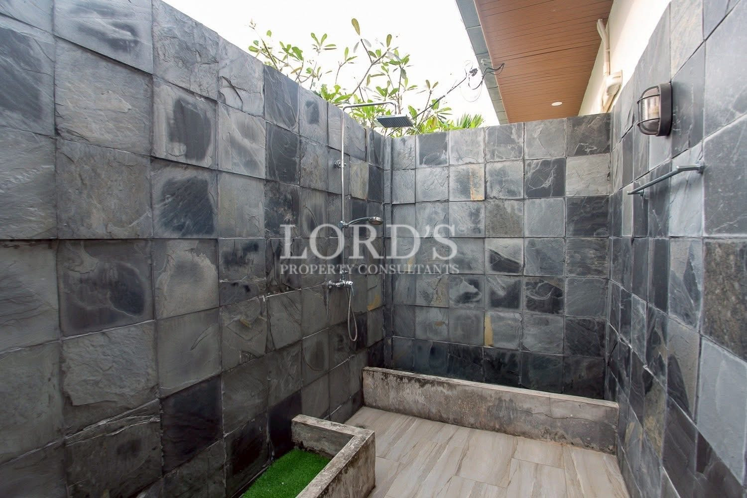 Outdoor stone shower in tropical garden