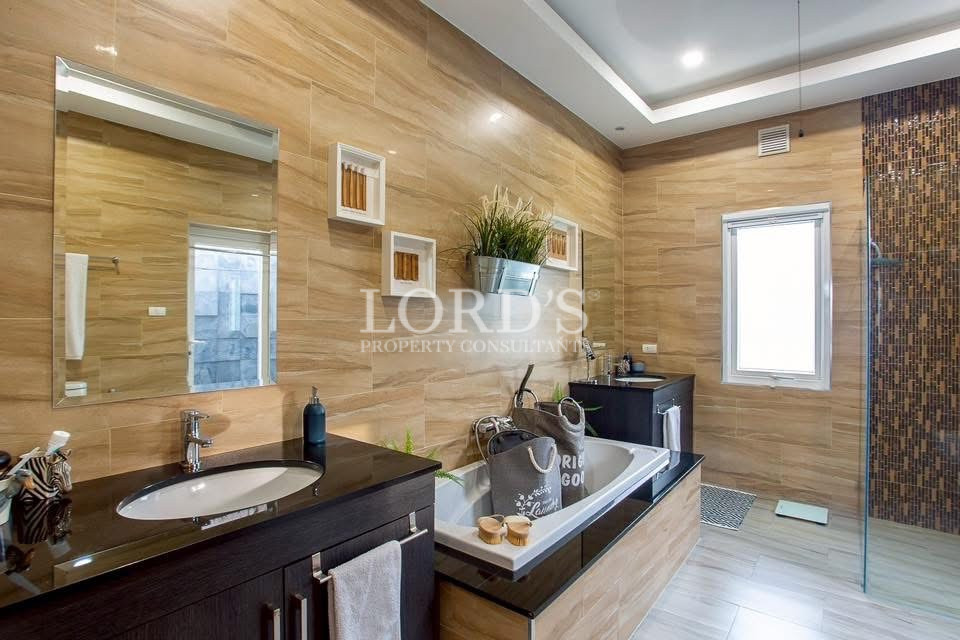 Bathroom with double vanity and wood accents