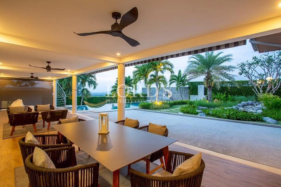 Covered outdoor terrace overlooking pool