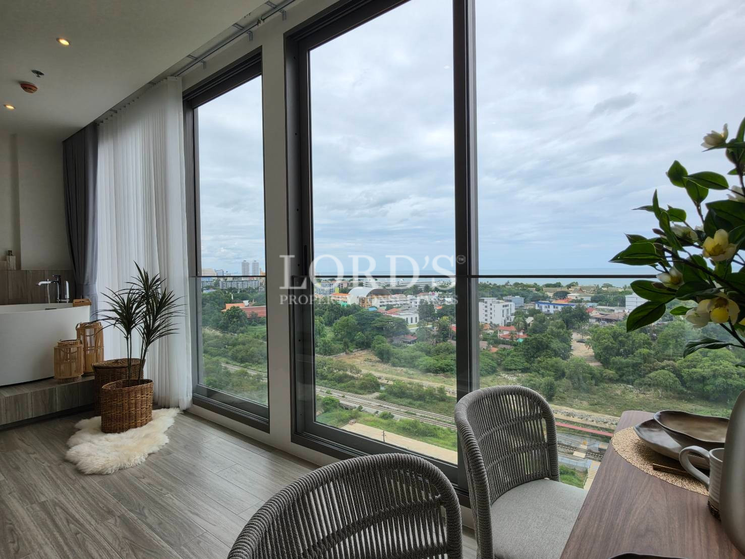 Large picture windows with modern interior and cityscape views