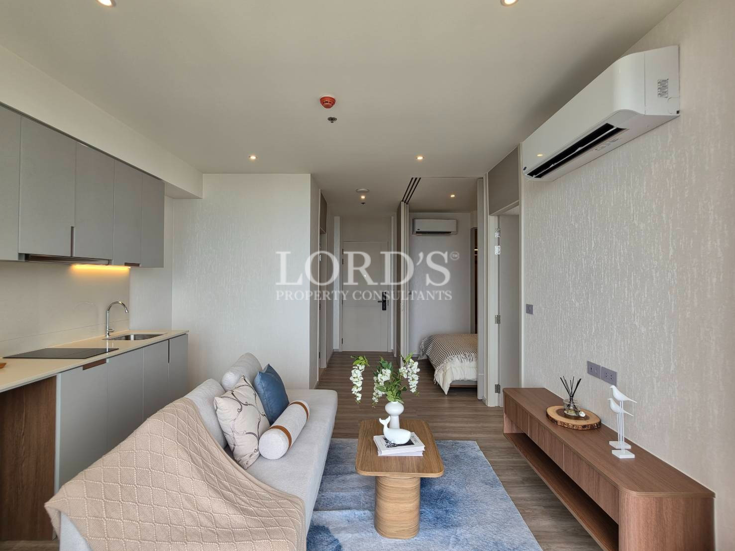 Contemporary bedroom with wall-mounted air conditioner and large windows