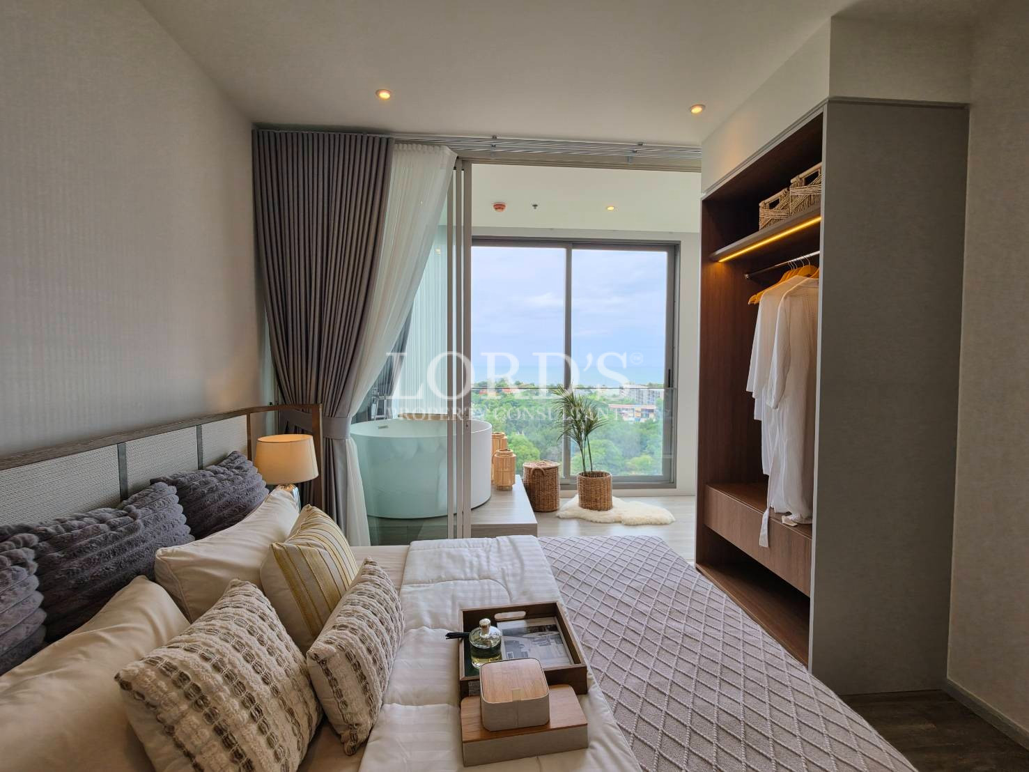Spacious bedroom with balcony access and floor-to-ceiling windows