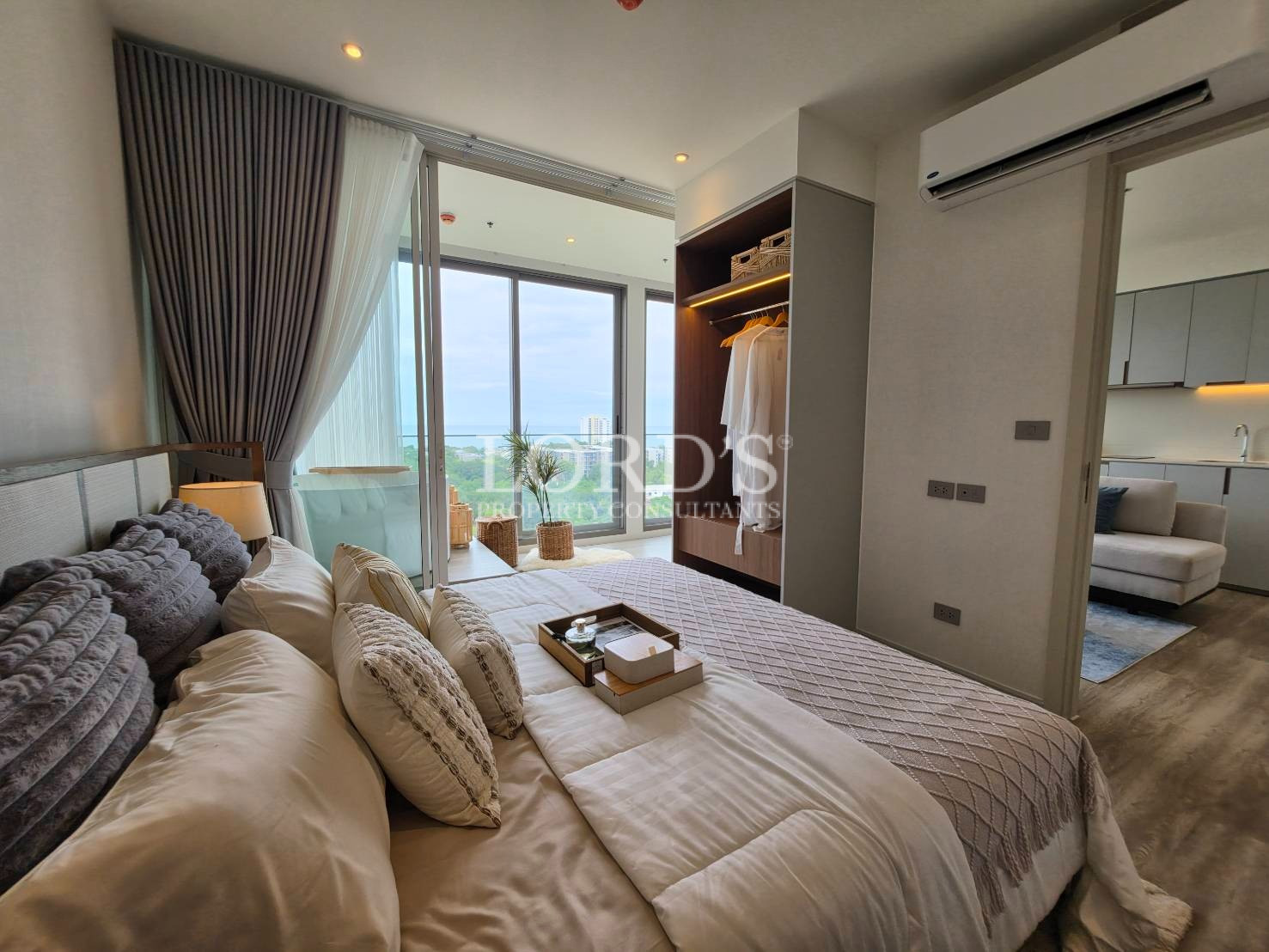 Bright modern bedroom with large windows and elegant curtains