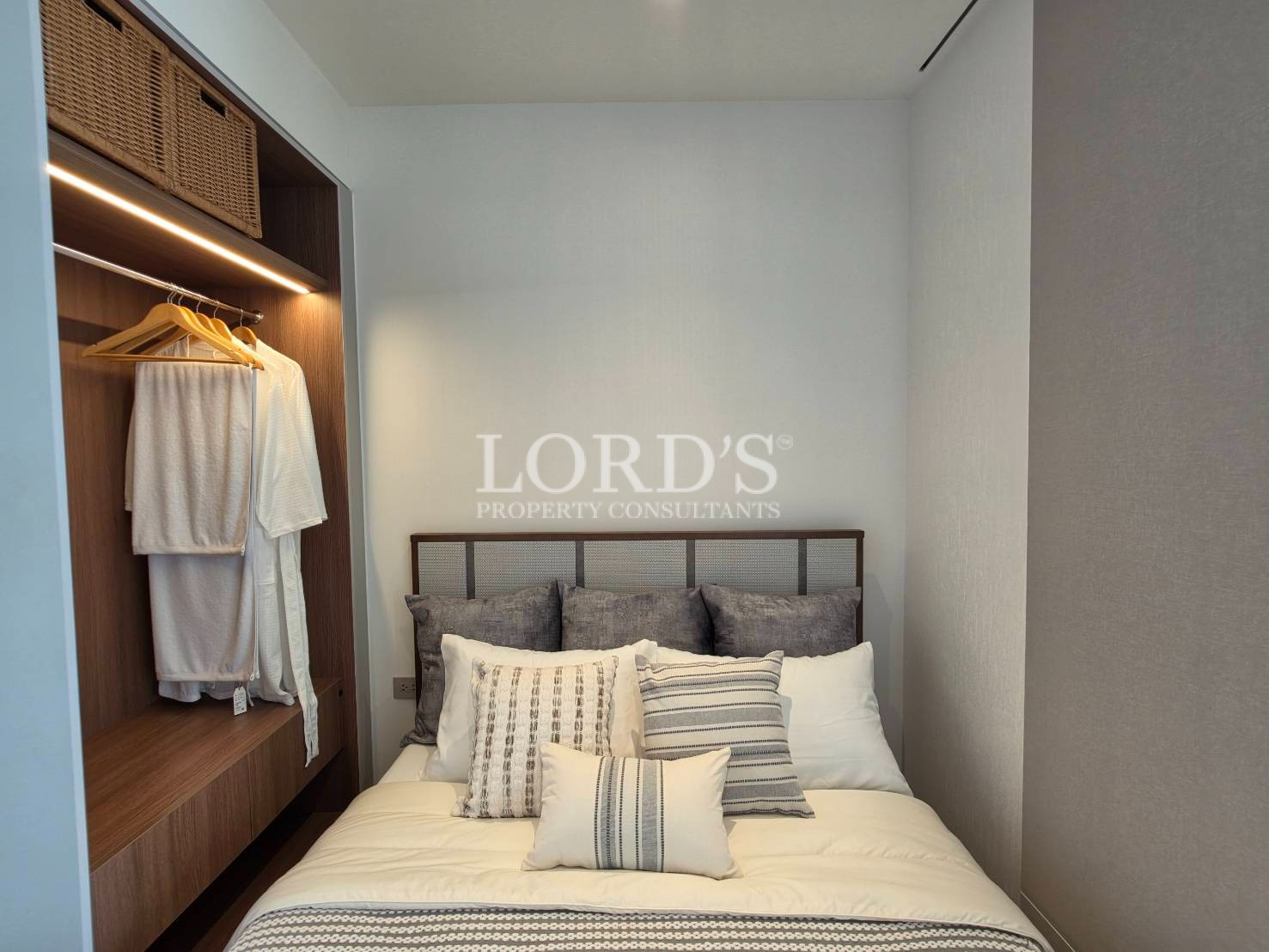Modern bedroom with custom wardrobe and warm wood accents