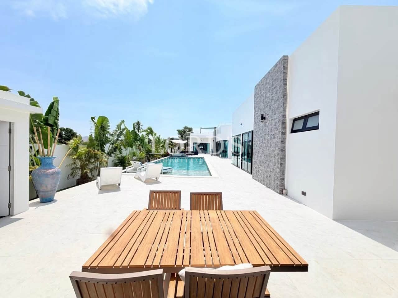Luxury villa patio with a private swimming pool and outdoor dining area