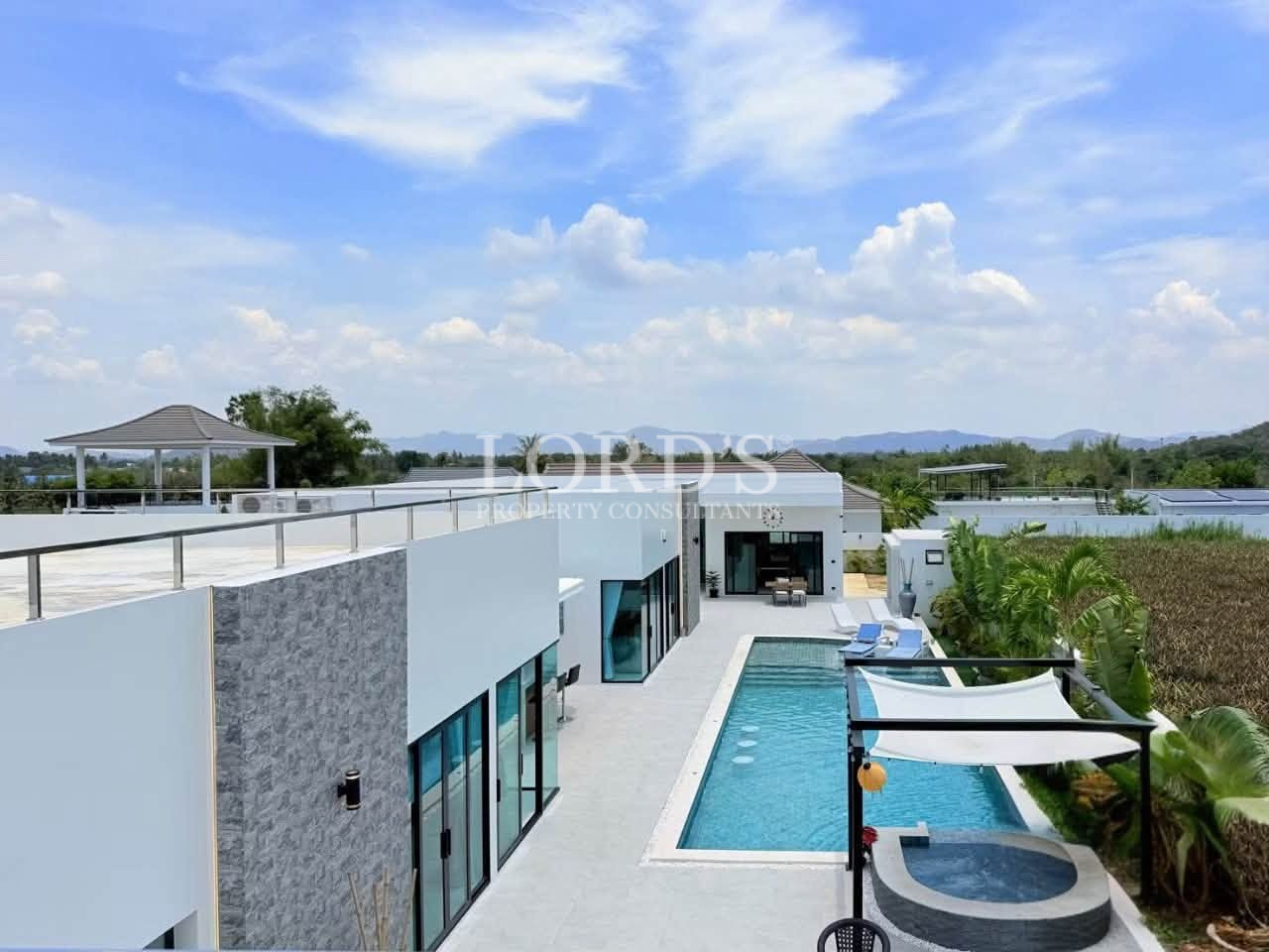 Luxury modern villa with a private swimming pool, rooftop terrace, and mountain views