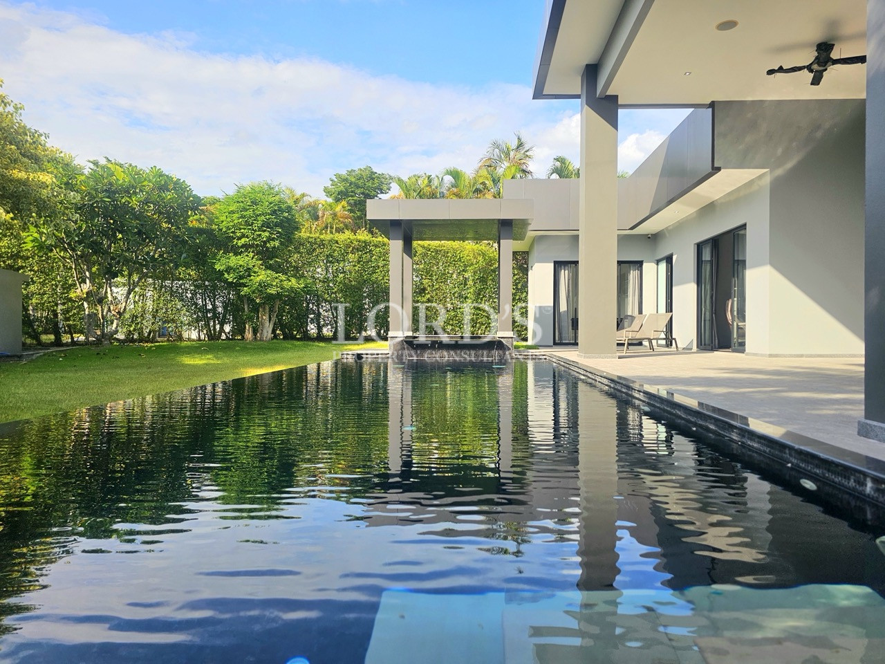 Luxury modern villa with private swimming pool, covered patio, landscaped garden, and contemporary outdoor living space