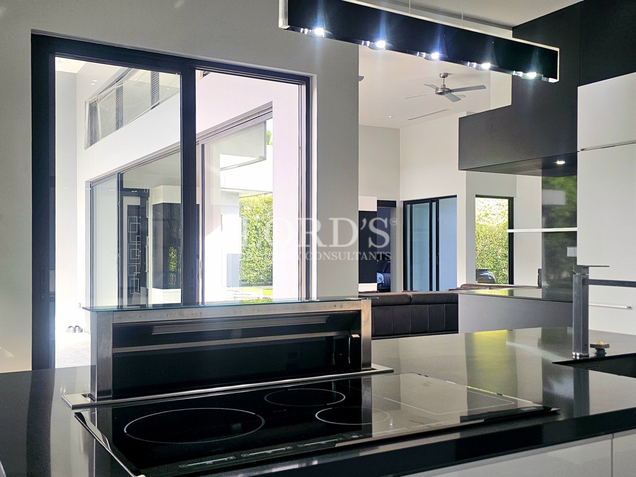 Modern luxury kitchen island with built-in induction cooktop and downdraft extractor