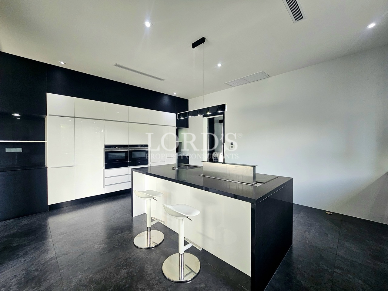 Modern luxury kitchen with black and white island and built-in appliances