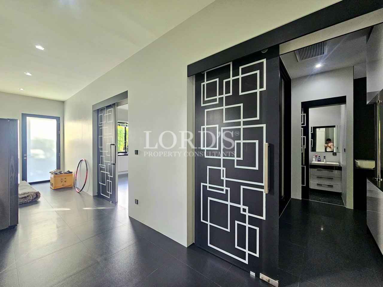 Designer hallway with decorative sliding doors and ensuite entrance