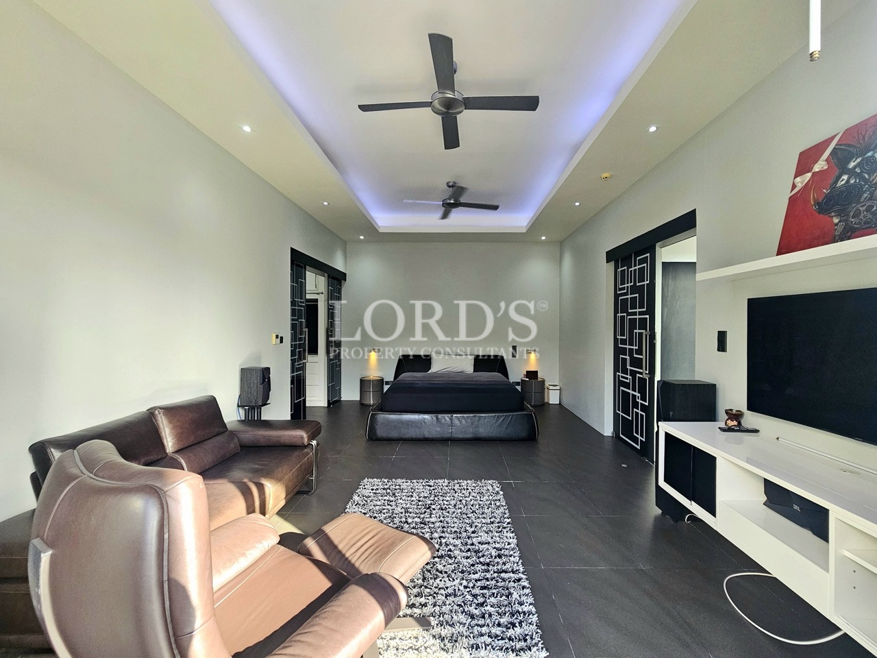 Expansive master suite with lounge area and entertainment center