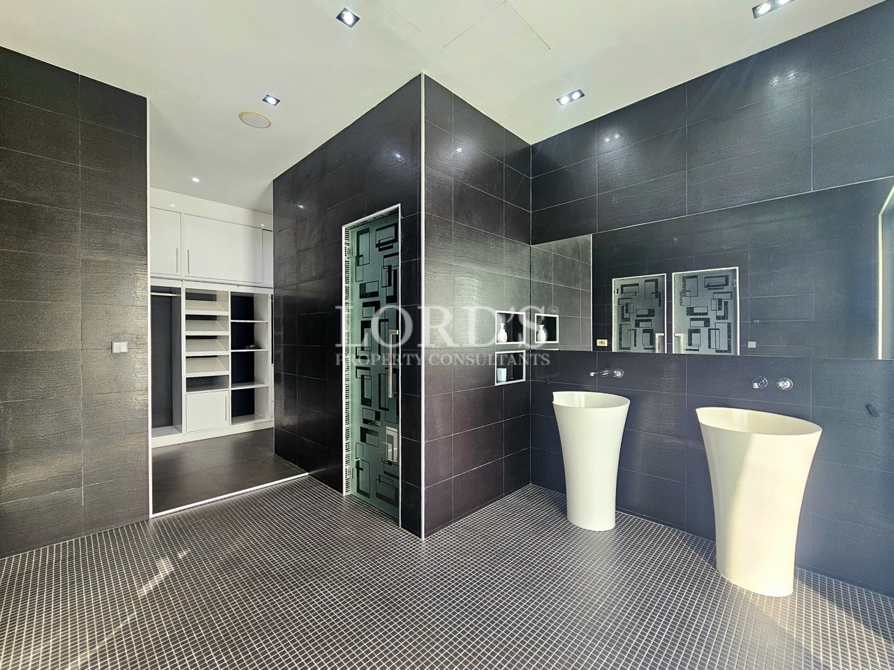Luxury ensuite bathroom with double pedestal sinks and modern design