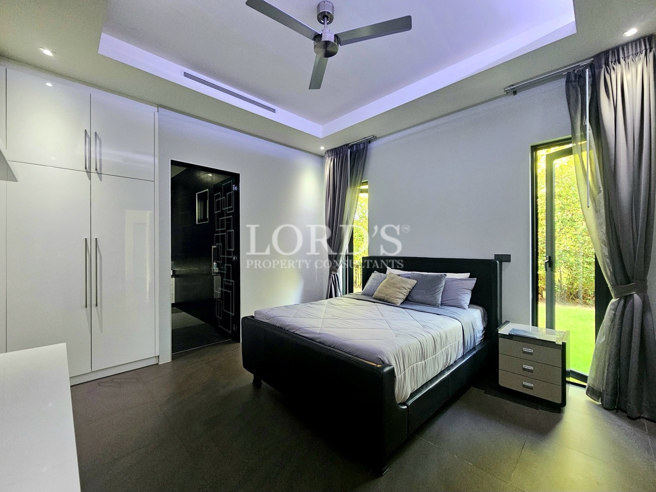 Elegant master bedroom with garden views and ensuite bathroom