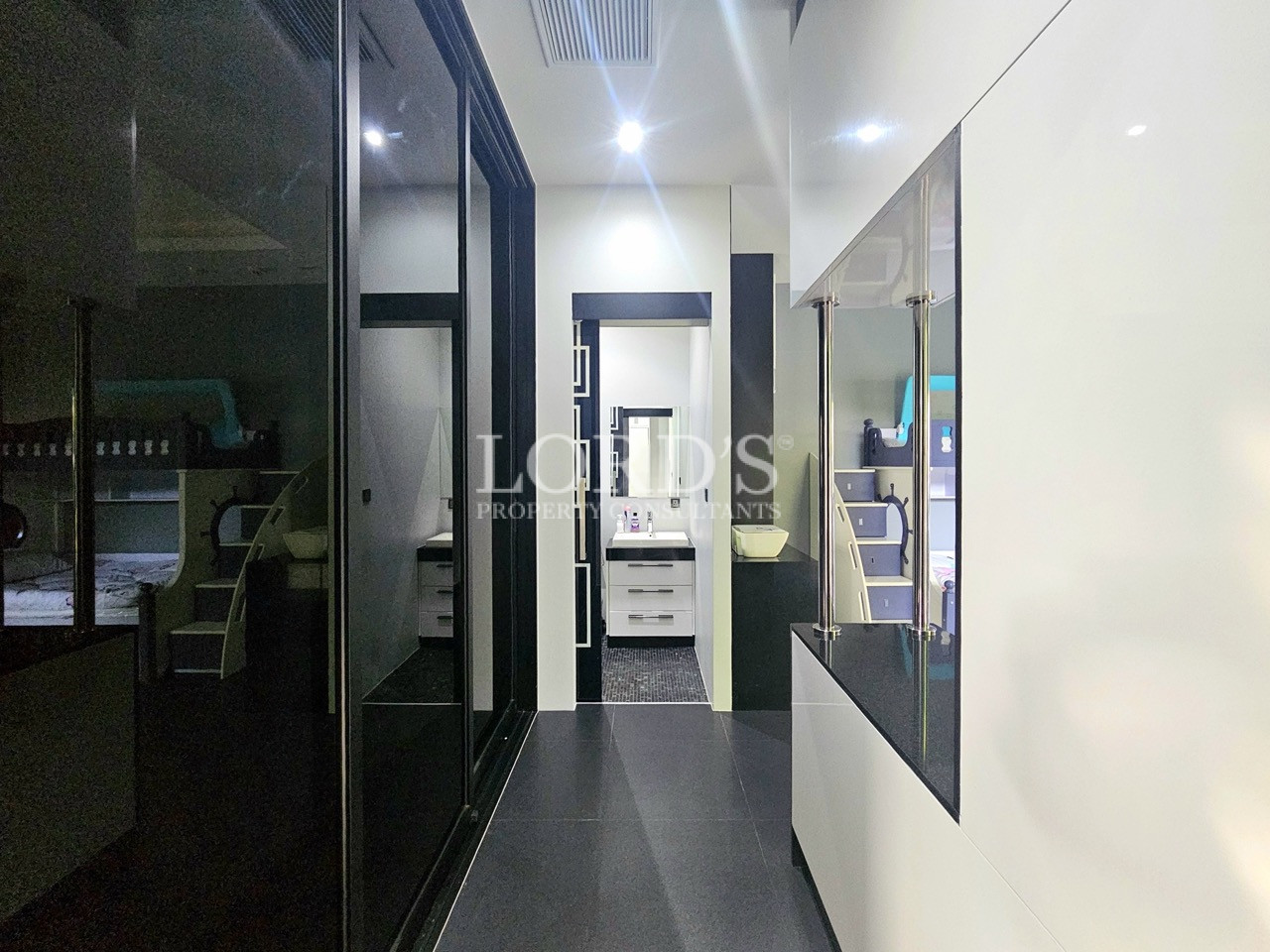 Contemporary hallway with built-in storage leading to family bedroom